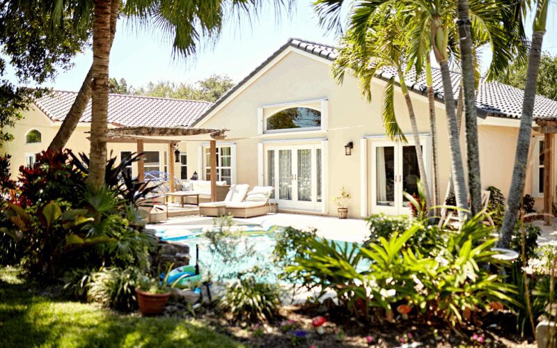 Tropical house with pool and lush garden.